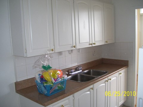 a kitchen with white cabinets and a sink